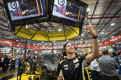 Supercars champion Chas Mostert takes a selfie in the new Supercheap Auto Customer Experience Centre.