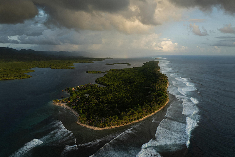 Title: The Last Dolphin HuntersCredit: &copy; Matthew Abbott, Oculi, for The New York TimesCaption: Fanalei Island has been reduced to a narrow strip of sand and coral by rising seas. Residents believe the settlement, once home to dozens of families, will become uninhabitable in the near future. South Malaita, Solomon Islands, 6 February 2025. Story: Fanalei, a low-lying island in the Solomon Islands, stands at a crossroads between contested tradition and a changing economy. For generations, dolphin hunting provided food and income, with dolphin teeth used as ritual currency for bride-price and other forms of local exchange. Today, as rising sea levels displace the community and threaten its future, seaweed farming is providing an economic alternative to the seasonal hunt. As seaweed farming expands, fewer people are available for the collective efforts upon which dolphin hunting depends. This story captures a community reshaped by environmental pressure and shifting traditions.